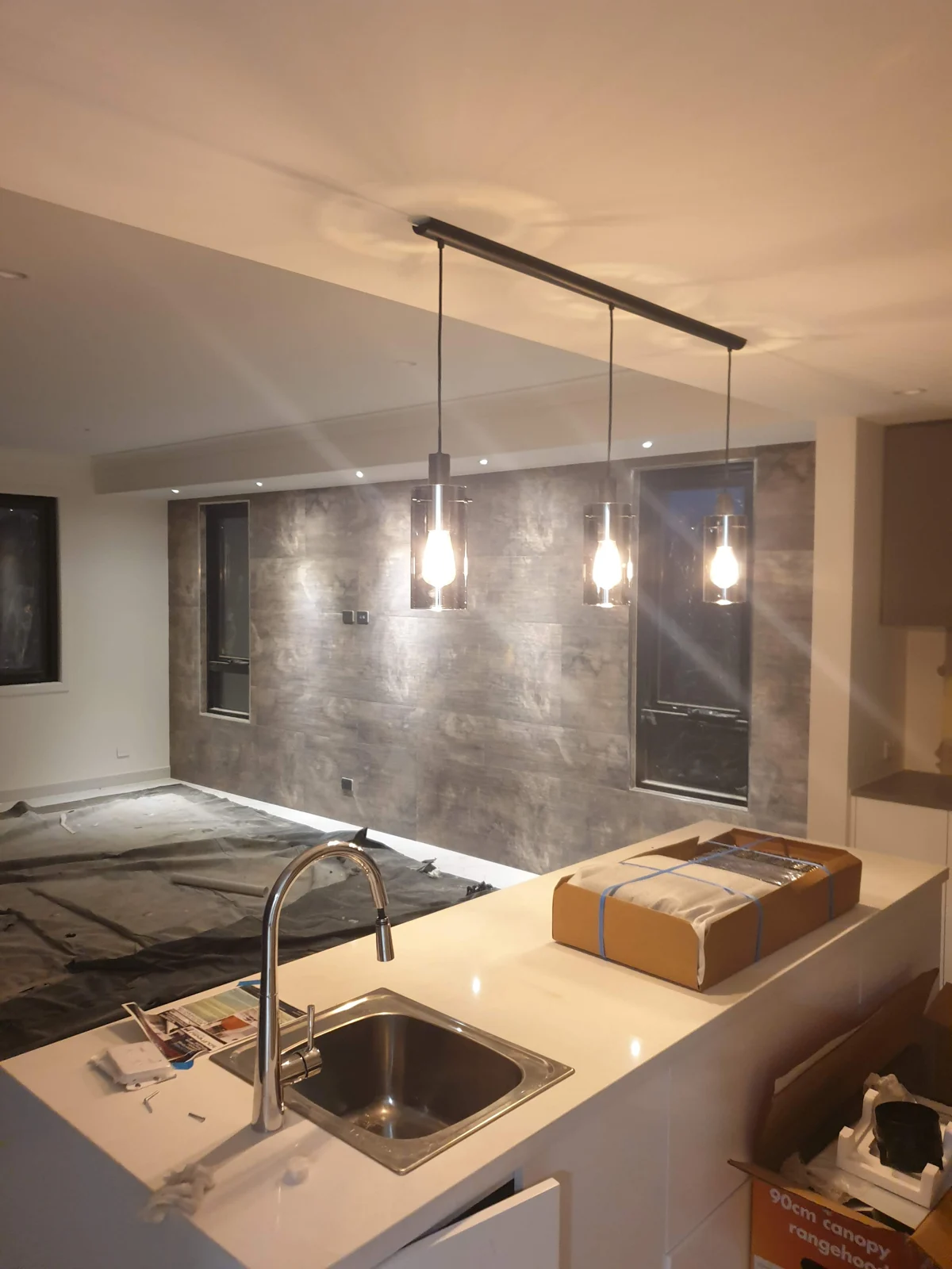 Completed residential kitchen with electrical fittings and lighting